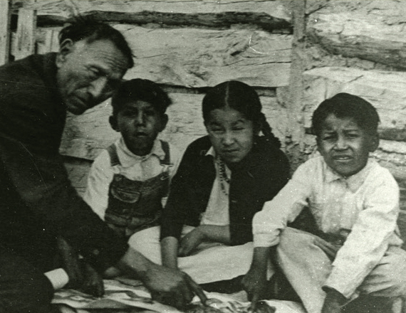 A black and white photo of a man and three children