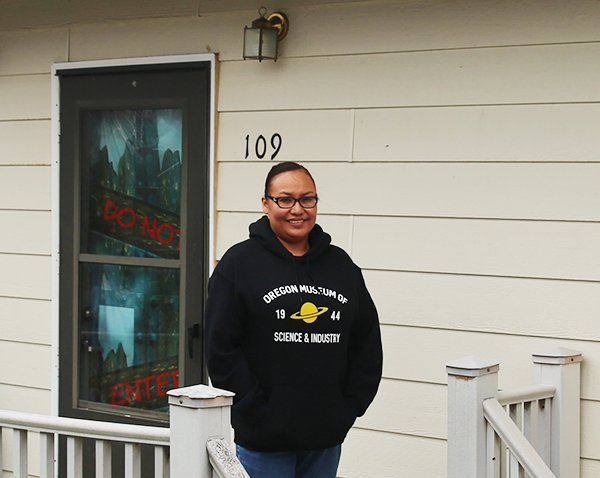 Lauren in front of her RCIS home
